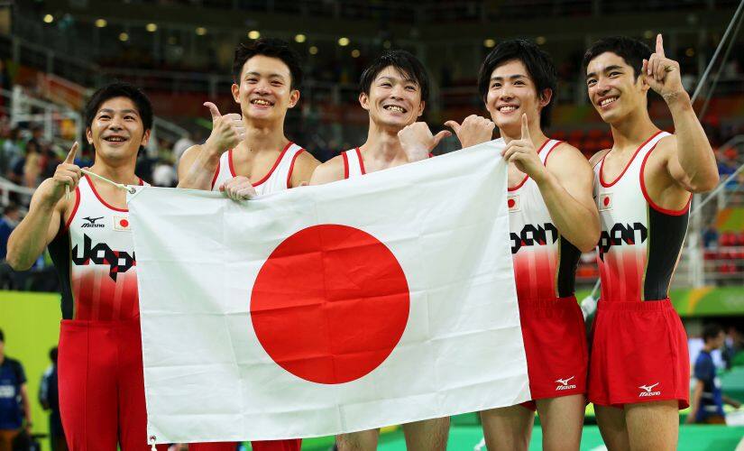 Koji Yamauro, Yusuke Tanaka, Kohei Uchimura, Ryohei Kato and Kenzo Shirai of Japan pose after winning the gold medal. Getty