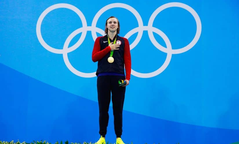 Katie Ledecky poses on the podium during the medal ceremony. Getty