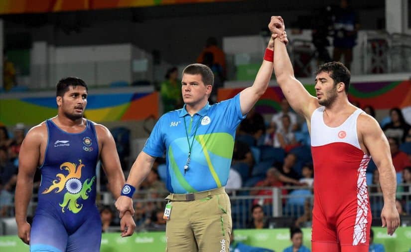 Ildem Cenk of Turkey is declared winner against India's Hardeep Singh in Men's 98 Kg wrestling. PTI 