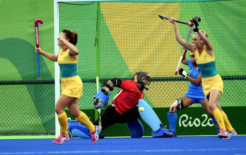 India's goalkeeper Savita looks on as Australia's players celebrate their goal. PTI 