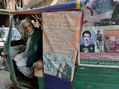 Pakistan's Olympian Muhammad Ashiq pictured in his auto-rickshaw in Lahore. AFP