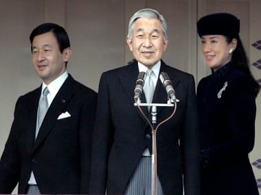 FILE - In this Dec. 23, 2007, file photo, Japan's Emperor Akihito, center, stands as Crown Prince Naruhito and his wife Crown Princess Masako enter a bulletproof balcony at Imperial Palace in Tokyo for a public appearance by the emperor. Akihito’s video message Monday, Aug. 8, 2016, though subtle, conveyed his wish to abdicate, and the attention now goes to his elder son, Naruhito, the first in line to Japan’s Chrysanthemum throne. (AP Photo/Shizuo Kambayashi, File)