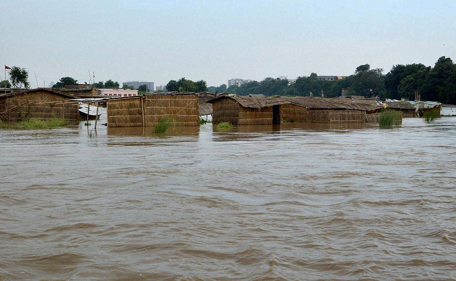 The water level in Ganga river swelled following heavy downpour, threatening inundation of areas close by. Although the flood situation eased, the river remained above danger mark. Photo: PTI The water level in Ganga river swelled following heavy downpour, threatening inundation of areas close by. Although the flood situation eased, the river remained above danger mark. Photo: PTI