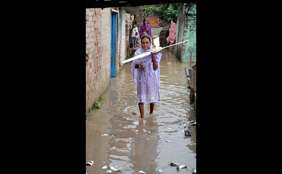 Although the Disaster Management Department said that no district was in the grip of floods, water entered a few villages located close to the low-lying areas. It disrupted normal life as people were forced to traverse through floodwater. Photo: PTI Although the Disaster Management Department said that no district was in the grip of floods, water entered a few villages located close to the low-lying areas. It disrupted normal life as people were forced to traverse through floodwater. Photo: PTI