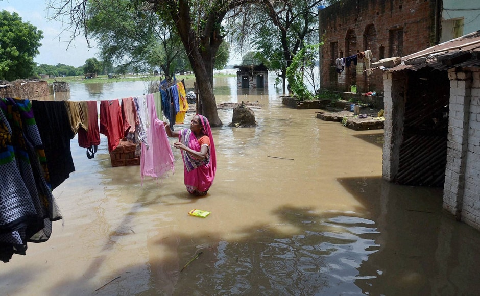 Incessant rains in many parts of Uttar Pradesh have resulted in floods. A woman can be seen drying clothes in a flooded area in Mirzapur. Six persons of a family were killed in the area when the car they were travelling fell into an overflowing drain. Photo: PTI Incessant rains in many parts of Uttar Pradesh have resulted in floods. A woman can be seen drying clothes in a flooded area in Mirzapur. Six persons of a family were killed in the area when the car they were travelling fell into an overflowing drain. Photo: PTI