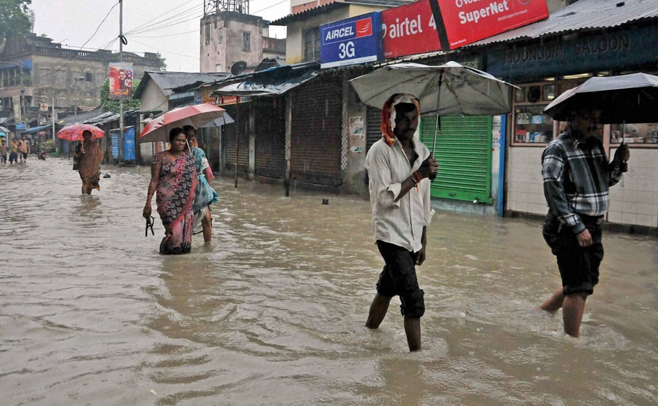 West Bengal is on high alert after a deep depression near the coastal town of Digha has brought heavy rainfall in all southern districts of the state. People have to move through water logged road at Kalighat Kali temple area in Kolkata on Sunday. Photo: PTI West Bengal is on high alert after a deep depression near the coastal town of Digha has brought heavy rainfall in all southern districts of the state. People have to move through water logged road at Kalighat Kali temple area in Kolkata on Sunday. Photo: PTI