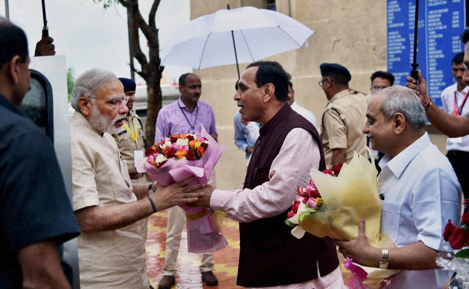 Modi being welcomed by the Chief Minister of Gujarat Vijay Rupani, on his arrival at AJI-3 dam site of SAUNI project, in Jamnagar district. PTI Modi being welcomed by the Chief Minister of Gujarat Vijay Rupani, on his arrival at AJI-3 dam site of SAUNI project, in Jamnagar district. PTI