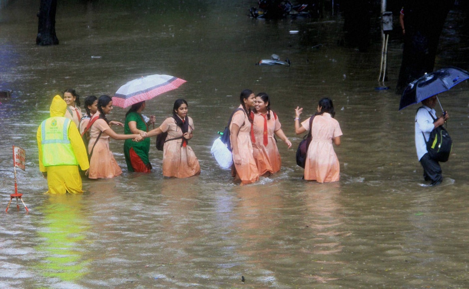 School children wading through flooded street during heavy rains in Mumbai on Friday. Besides Mumbai, the adjoining districts of Thane, Palghar and Raigad were also lashed by heavy rains, slowing traffic on all major routes linking Mumbai to Ahmedabad, Pune, Nashik and Goa. PTI School children wading through flooded street during heavy rains in Mumbai on Friday. Besides Mumbai, the adjoining districts of Thane, Palghar and Raigad were also lashed by heavy rains, slowing traffic on all major routes linking Mumbai to Ahmedabad, Pune, Nashik and Goa. PTI
