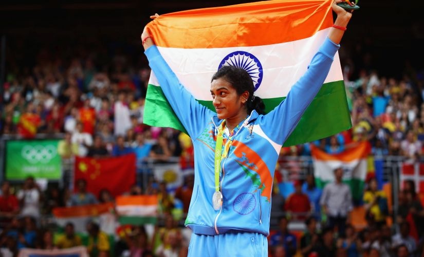 PV Sindhu stands proud with the Indian flag and her silver medal. Getty