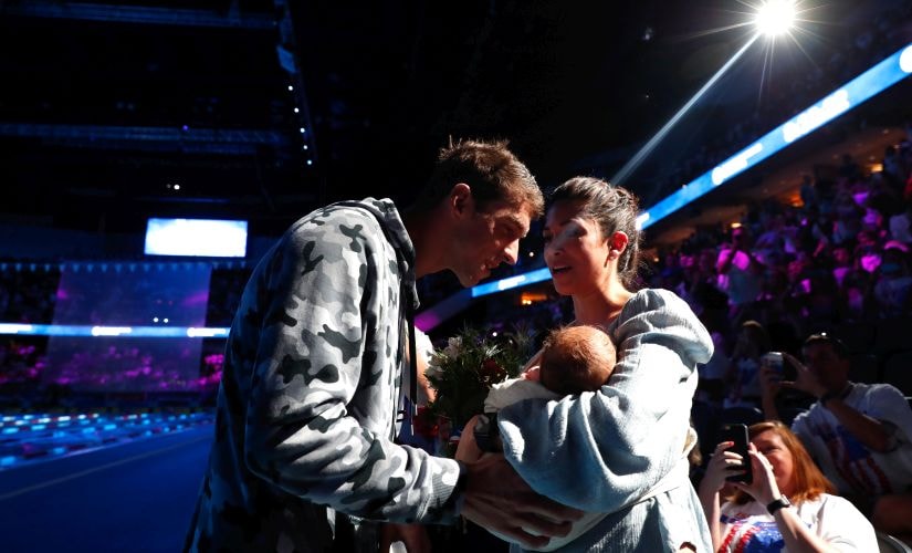 Michael Phelps with longtime partner Nicole Johnson and son Boomer Phelps. Getty