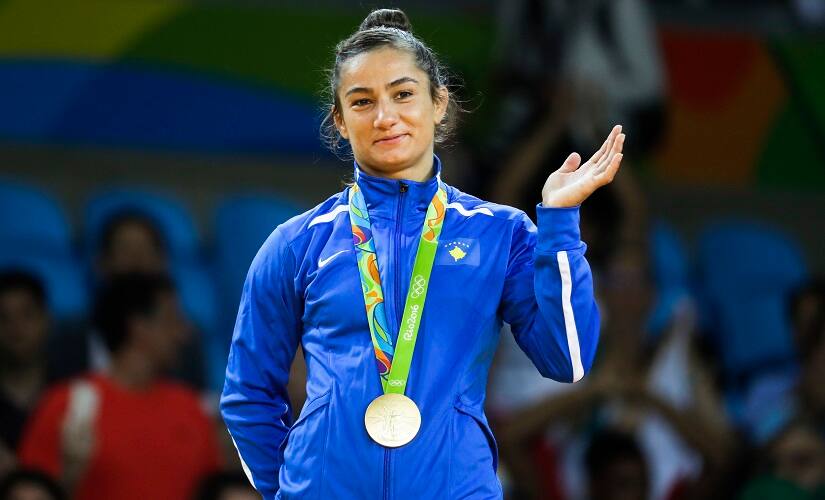 Kosovo's Majlinda Kelmendi receives the gold medal after winning the women's 52-kg judo competition at the 2016 Summer Olympics in Rio de Janeiro, Brazil, Sunday, Aug. 7, 2016. (AP Photo/Markus Schreiber)