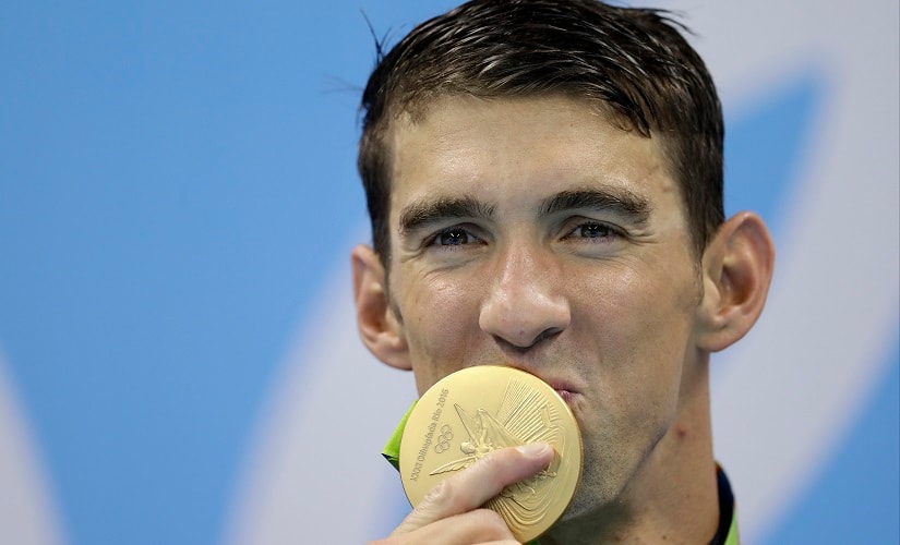 United States' Michael Phelps kisses his gold medal after the men's 4x100-meter freestyle final during the swimming competitions at the 2016 Summer Olympics, Monday, Aug. 8, 2016, in Rio de Janeiro, Brazil. (AP Photo/Michael Sohn)