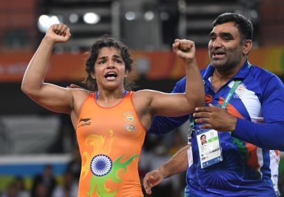 India's Sakshi Malik celebrates after winning against Kirghyzstan's Aisuluu Tynybekova in their women's 58kg freestyle bronze medal match. AFP