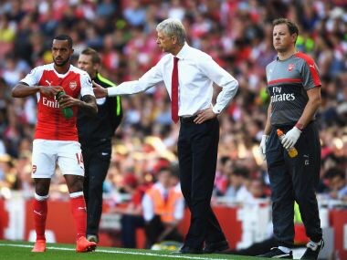 Arsene Wenger talking to Theo Walcott during the Arsenal vs Liverpool game. Getty