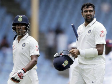 Wriddhiman Saha (left) and Ravichandran Ashwin. PTI