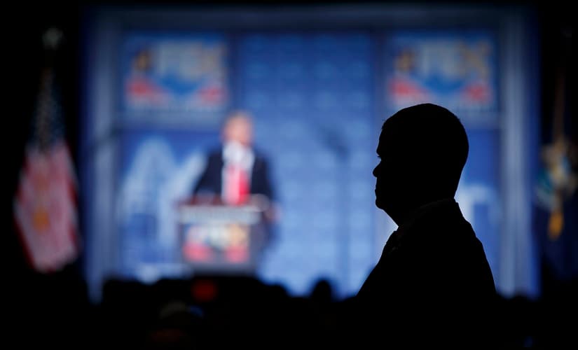 A security guard stands guard as Republican presidential candidate Donald Trump delivers an economic policy speech to the Detroit Economic Club on Monday. AP