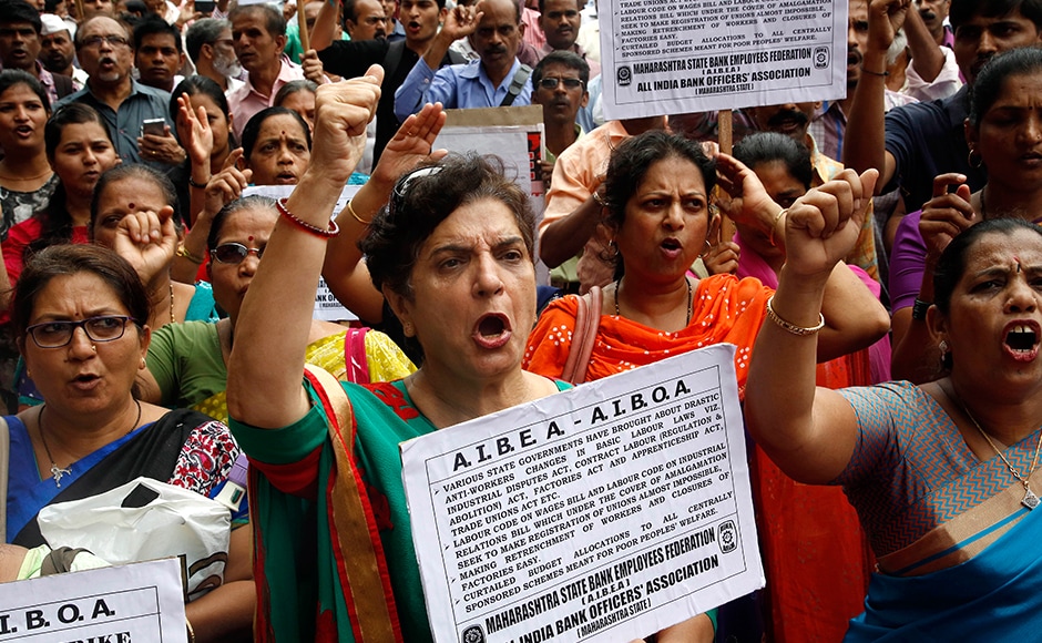 Indian government and bank employees shout slogans as they participates in a protest during a nationwide strike called by trade unions in Mumbai. The strike howveer evoked a mixed response in Maharashtra. AP Indian government and bank employees shout slogans as they participates in a protest during a nationwide strike called by trade unions in Mumbai. The strike howveer evoked a mixed response in Maharashtra. AP