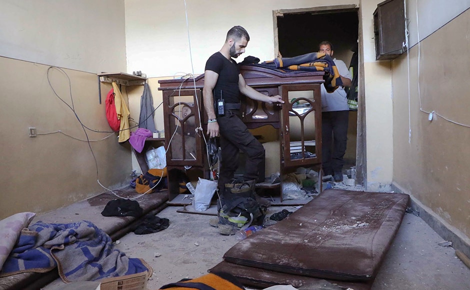 The air strikes come as Syria's military command announced it is launching operations in Aleppo's rebel-held eastern quarters. Rescue workers checked the damage inside the Syrian Civil Defense main center after the air strikes. Photo: AP The air strikes come as Syria's military command announced it is launching operations in Aleppo's rebel-held eastern quarters. Rescue workers checked the damage inside the Syrian Civil Defense main center after the air strikes. Photo: AP