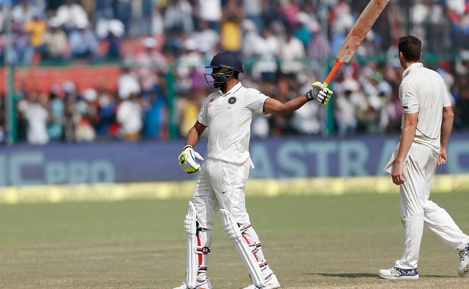 India's Ravindra Jadeja raises bat after scoring fifty runs on the fourth day of their first cricket test match against New Zealand at Green Park Stadium in Kanpur, India, Sunday, Sept. 25, 2016. (AP Photo/ Tsering Topgyal)