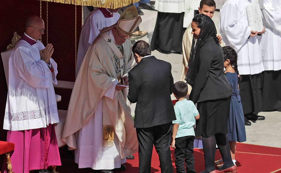 Brazilian mechanical engineer Marcilio Andrino, (left with back to camera) and his wife Fernanda Nascimento Rocha greet Pope Francis during the Canoninsation Mass at the Vatican on Sunday. Andrino's cure of a viral brain infection, declared a miracle by Pope Francis earlier this year, was the final step needed to declare Mother Teresa a saint. AP Brazilian mechanical engineer Marcilio Andrino, (left with back to camera) and his wife Fernanda Nascimento Rocha greet Pope Francis during the Canoninsation Mass at the Vatican on Sunday. Andrino's cure of a viral brain infection, declared a miracle by Pope Francis earlier this year, was the final step needed to declare Mother Teresa a saint. AP