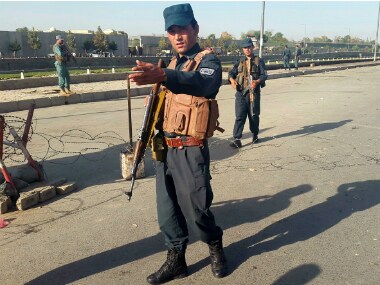 Afghan policemen stand guard at the site of a blast in Kabul on Monday. Reuters