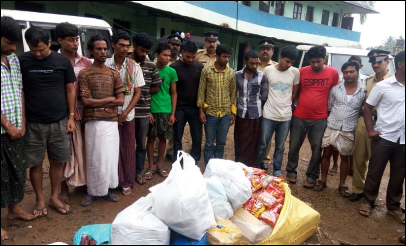 Excise team with migrant labourers after a raid at a labour camp in Perumbavoor. Firstpost/Naveen Nair