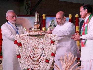 PM Modi with BJP President Amit Shah lights the lamp as Union Minister Venkaiah Naidu looks on during BJP's National Council Meeting in Kozhikode . PTI
