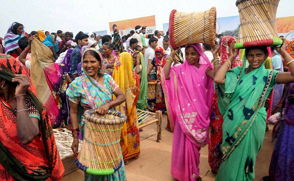 Congress party supporters gleefully take away Modas (Cane stools) after the Khat pe Charcha programme ended in Mirzapur on Wednesday. (Photo: PTI) Congress party supporters gleefully take away Modas (Cane stools) after the Khat pe Charcha programme ended in Mirzapur on Wednesday. (Photo: PTI)