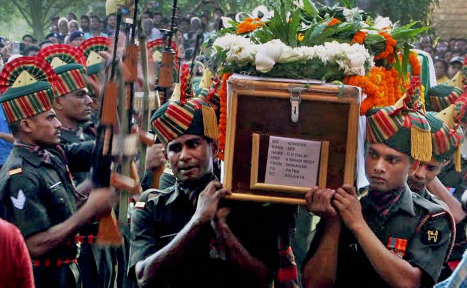 Army jawans carry the coffin of Sepoy Gangadhar Dolui, who was martyred in Uri attack, in Howrah on Tuesday. PTI Army jawans carry the coffin of Sepoy Gangadhar Dolui, who was martyred in Uri attack, in Howrah on Tuesday. PTI