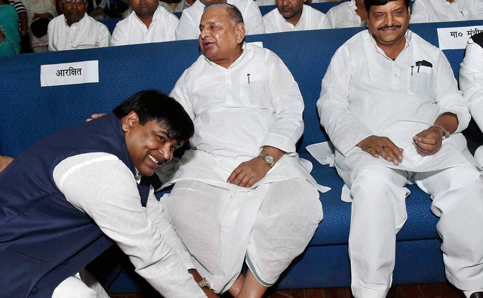 Much to the amusement of those present at the Raj Bhawan, a beaming Prajapati sat at the feet of SP supremo Mulayam Singh Yadav for photojournalists. (Photo: PTI) Much to the amusement of those present at the Raj Bhawan, a beaming Prajapati sat at the feet of SP supremo Mulayam Singh Yadav for photojournalists. (Photo: PTI)