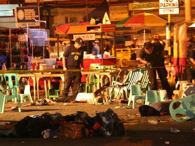 Police search the site of the explosion. AP