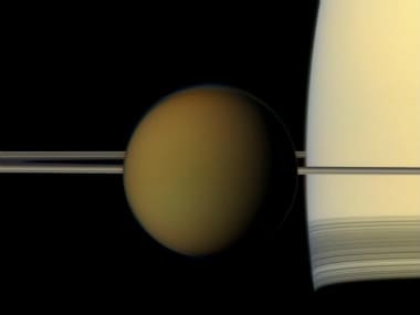 The hazy globe of Titan hangs in front of Saturn and its rings in this natural color view from NASA's Cassini spacecraft. (Photo: NASA/JPL-Caltech/Space Science Institute)