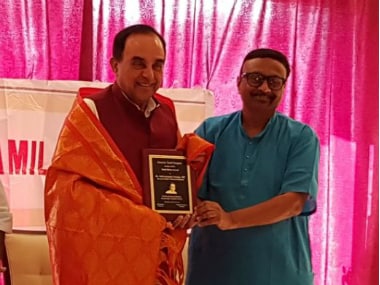 Swamy receiving the 'Tamil Ratna' award. Twitter/ @jagdishshetty