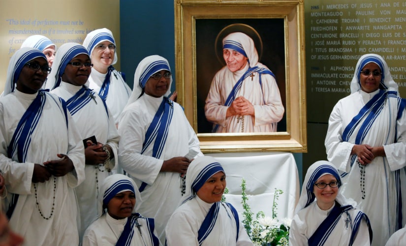 Members of Mother Teresa's order, the Missionaries of Charity, gather around the official canonisation portrait of Mother Teresa after the unveiling at the John Paul II National Shrine in Washington, US on Thursday. Reuters