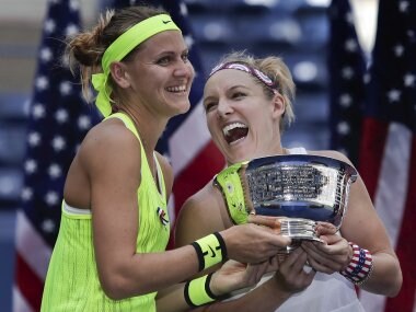 Lucie Safarova and Bethanie Mattek-Sands hold the US Open women's doubles championship trophy. AP