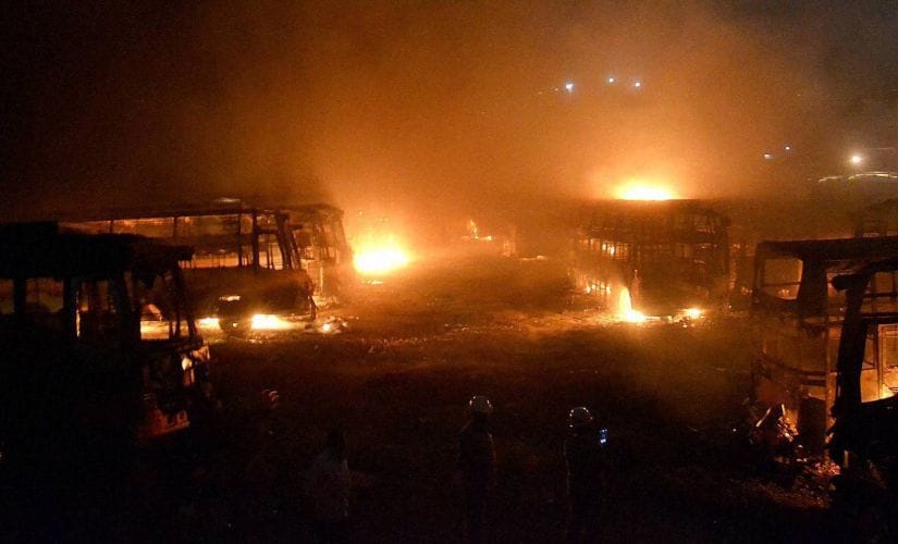 Tamil Nadu bound buses in flames after they were torched by pro-Kannada activists during a protest over Cauvery water row, in Bengaluru on Monday. PTI