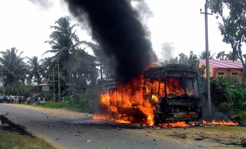 A vehicle in flames after it was torched by pro-Kannada activists during a protest over Cauvery water row, in Mandya district on Monday. PTI