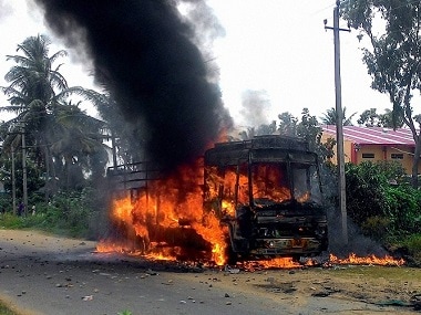 A file image of a vehicle in flames after it was torched by pro-Kannada activists during a protest over Cauvery water row, in Mandya district. PTI