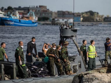 Egyptian rescue workers bringing ashore the bodies. AP