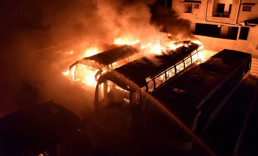 TN-bound buses in flames after they were torched by pro-Kannada activists during a protest over the Cauvery water row, on Monday. PTI