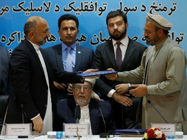 Representatives of the Afghanistan government and Hekmatyar sign a peace deal. Reuters