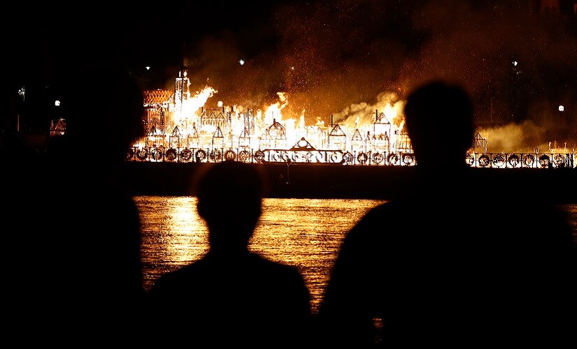 People watch as a 120-metre long sculpture of the 17th Century London skyline was set alight in a retelling of the story of the Great Fire of London in 1666. AP
