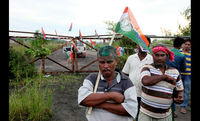 Trinamool Congress supporters in front of the gates of the deserted factory in Singur. Firspost/Saadia Azim