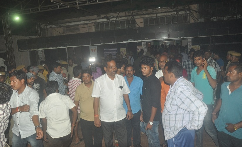 Relatives of patients admitted at SUM Hospital anxiously await news of their kin. Firstpost/Biswa Ranjan