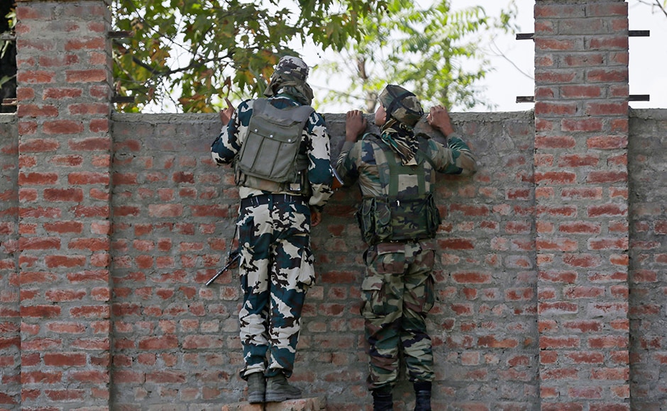 The soldier was hit by a bullet and sent to a nearby hospital. Security forces surrounded the building and sealed all escape routes. Photo: AP The soldier was hit by a bullet and sent to a nearby hospital. Security forces surrounded the building and sealed all escape routes. Photo: AP