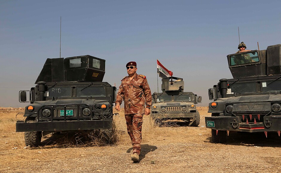 The Commander of the Joint Military Operation Commander, Army Lt. Gen. Talib Shaghati, walks in the town of Khazer, Iraq, Monday, Oct. 17, 2016. He praised the role of the U.S.-led International Coalition as The Commander of the Joint Military Operation Commander, Army Lt. Gen. Talib Shaghati, walks in the town of Khazer, Iraq, Monday, Oct. 17, 2016. He praised the role of the U.S.-led International Coalition as