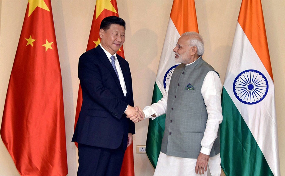 Prime Minister Narendra Modi greets Chinese President Xi Jinping ahead of Brics summit in Goa on Saturday. (Photo: PTI) Prime Minister Narendra Modi greets Chinese President Xi Jinping ahead of Brics summit in Goa on Saturday. (Photo: PTI)