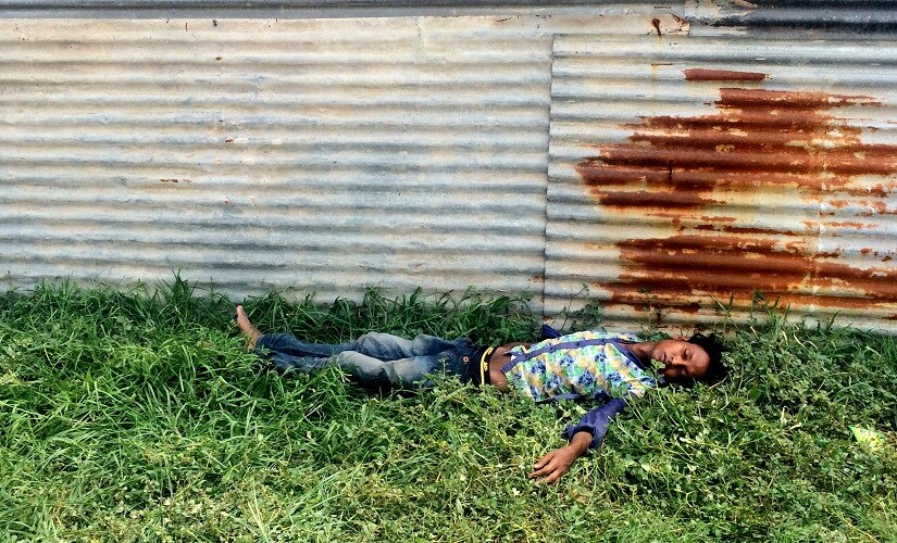 An addict passed out outside the New Usmanpur Police Station. Firstpost/Pallavi