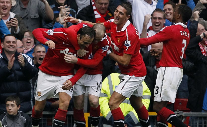 Manchester United's Dimitar Berbatov celebrates with teammates after scoring his third goal against Liverpool. Reuters