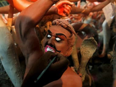 An artisan paints an idol of mythological demon Mahisasura ahead of the Durga Puja festival. Reuters